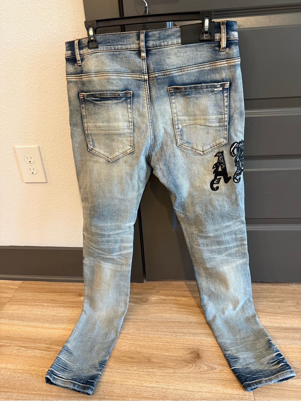 AMIRI Light Blue Distressed Slim Jeans with Black Embroidered Logo - Picture 2 of 2